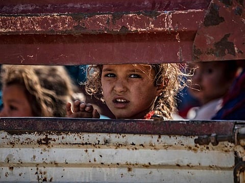 Syrian Arab and Kurdish civilians arrive to Tall Tamr town, in the Syrian northwestern Hasakeh province, after fleeing Turkish bombardment on the northeastern towns along the Turkish border on October 10, 2019.