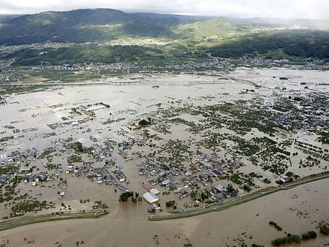 An aerial view shows residential areas flooded by the Chikuma river, caused by Typhoon Hagibis in Nagano, central Japan, Sunday.