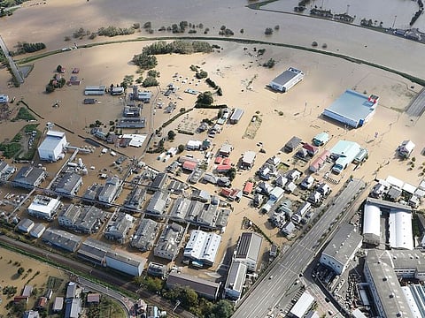 Houses in muddy waters in Sukagawa, Fukushima prefecture, as Typhoon Hagibis hits the area, northern Japan, Sunday, Oct. 13, 2019. Rescue efforts for people stranded in flooded areas are in full force after a powerful typhoon dashed heavy rainfall and winds through a widespread area of Japan, including Tokyo