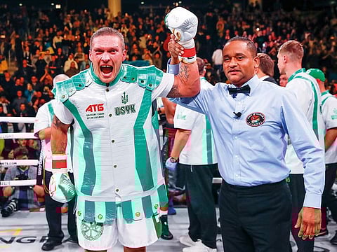 Oleksandr Usyk celebrates his win.