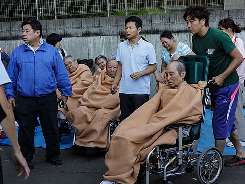Elderly people are rescued from a nursing home, flooded by Typhoon Hagibis, in Kawagoe, Japan, Oct. 13, 2019.