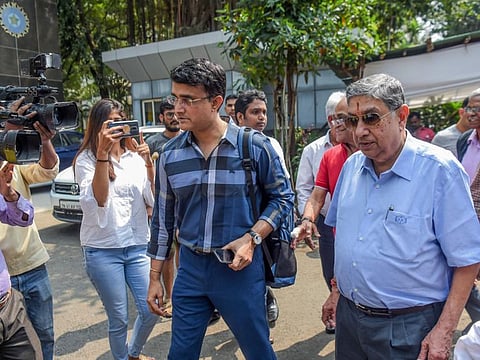 Sourav Ganguly (centre) is accompanied by former Board of Control for Cricket in India president N. Srinivasan and other senior officials as he arrives at the BCCI headquarters to file nomination for the board's elections in Mumbai on Monday.