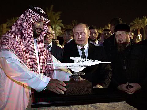Russian President Vladimir Putin presents a gift made of mammoth tusk to Saudi Arabia's Crown Prince Mohammed bin Salman as head of the Chechen Republic Ramzan Kadyrov looks on in Riyadh, Saudi Arabia, October 14, 2019.