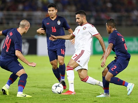 UAE's prolific striker Ali Mabkout (in white) being hemmed in by Thailand's Manuel Bihr, Phitiwat Sukjitthammakul and Sasalak Haiprakon during their World Cup qualifier today.