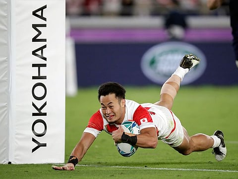 Japan’s Kenki Fukuoka scores a try during the Rugby World Cup Pool A game at International Stadium against Scotland in Yokohama.