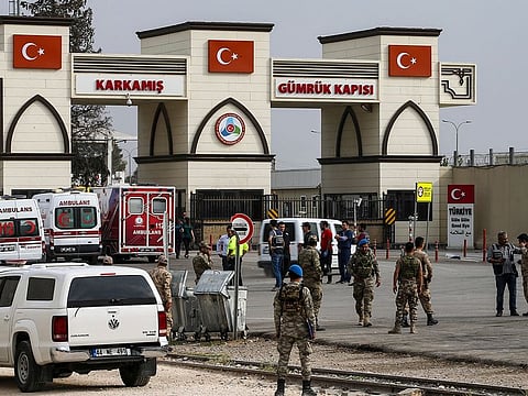 Turkish soldiers wait in the Karkamis border gate at Gaziantep province, southeastern Turkey, Wednesday, Oct. 16, 2019.