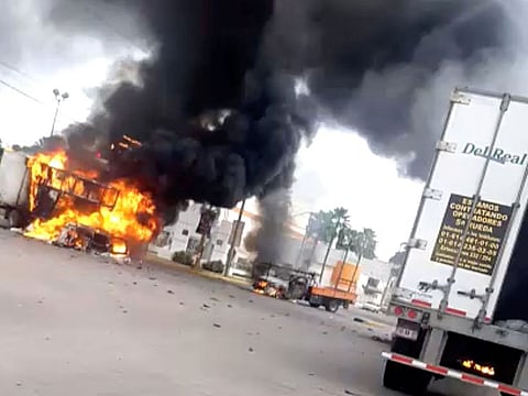 A vehicle burns as cartel members clash with federal forces over the detention of Ovidio Guzman, the son of drug kingpin Joaquin "El Chapo" Guzman, in Culiacan, Sinaloa state, Mexico October 17, 2019 in this still image taken from social media video. Content taken October 17, 2019.