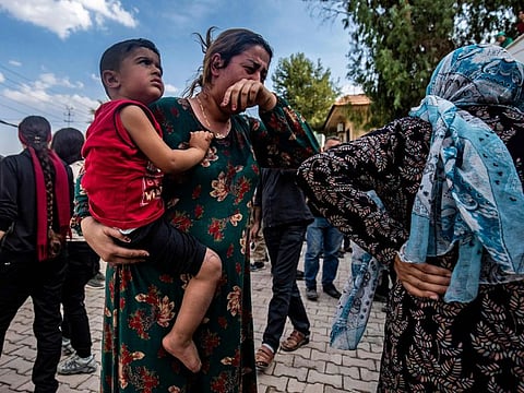 A woman reacts as the body of a man killed during Turkish shelling in the area surrounding the Syrian Kurdish town of Ras al-Ain arrives at a hospital in the nearby town of Tal Tamr following the announced ceasefire on October 18, 2019.