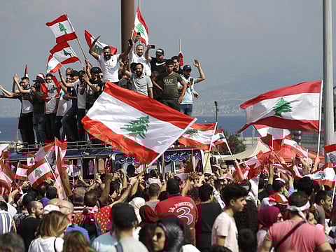 Anti-government protesters chant slogans and wave their national flags at Martyr's Square, in downtown Beirut, Lebanon, Sunday, October 20, 2019. Lebanon is bracing for what many expect to be the largest protests in the fourth day of anti-government demonstrations. Thousands of people of all ages were gathering in Beirut's central square Sunday waving Lebanese flags and chanting the, "people want to bring down the regime."