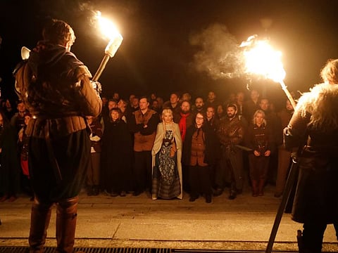 Participants hold torches during a role play event at the Moszna Castle in Moszna, Poland October 10, 2019. Fans of the 'Witcher' book and video game series attend a 'school' where they dress up in costume and role play witchers fighting supernatural creatures. The book series by Polish author Andrzej Sapkowski was made into an award-winning video game series, and streaming giant Netflix is expected to release a TV adaptation later this year. Picture taken October 10, 2019. REUTERS/Kacper Pempel