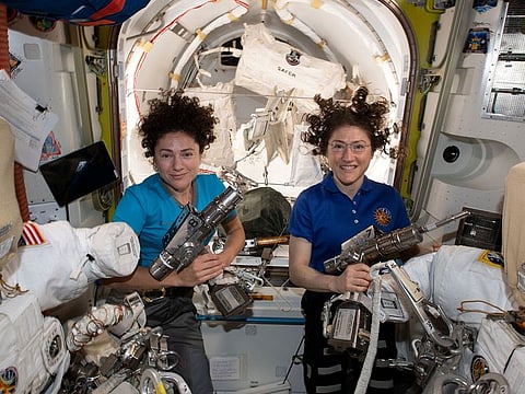 US astronauts Jessica Meir (L) and Christina Koch pose in the International Space Station.