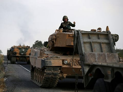 Turkish army vehicles are moving on a road near the Turkish border town of Ceylanpinar, Sanliurfa province, Turkey, October 18, 2019