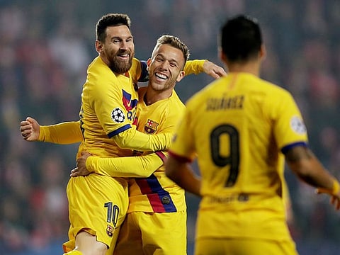 Barcelona's Lionel Messi celebrates scoring their first goal with Arthur.