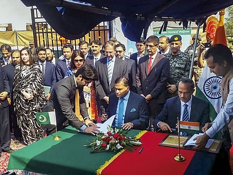 Officials from Pakistan and India sign an agreement on the Kartarpur corridor at Zero Point near Dera Baba Nanak in Gurdaspur district, Thursday.