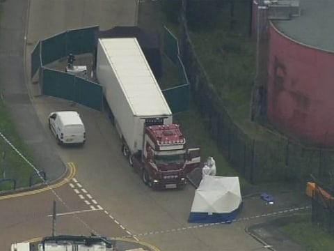 An aerial view as police forensic officers attend the scene after a truck was found to contain a large number of dead bodies, in Thurock, South England