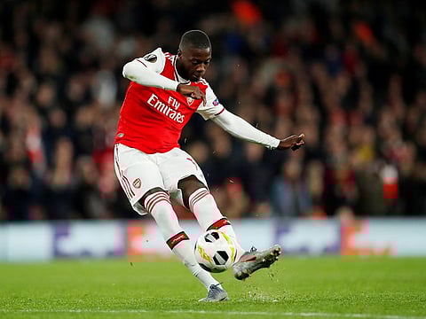Arsenal's Nicolas Pepe scores their third goal from a free kick.