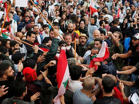Hezbollah and Amal supporters clash with protesters.