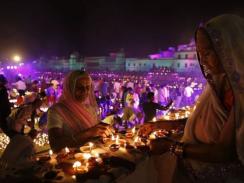 Indian Hindus light earthen lamps on the banks of the River Sarayu as part of Diwali celebrations in Ayodhya, India.