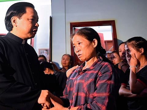 Tran Thi Hien (C), mother of Bui Thi Nhung, who is feared to be among the 39 people found dead in a truck in Britain, is consoled inside her house in Vietnam's Nghe An province on October 26, 2019.