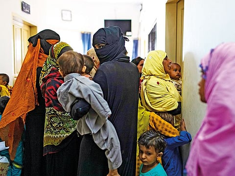 Patients wait to see a pediatrician at a hospital in Ratodero, Pakistan.