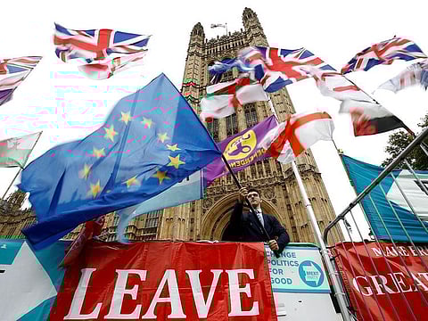 An anti-Brexit protester waves an EU flag outside the Houses of Parliament in London, Britain, October 25, 2019.
