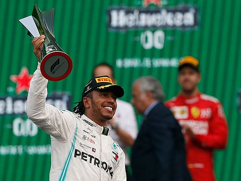 Mercedes driver Lewis Hamilton, of Britain, raises the winner's trophy of the Formula One Mexico Grand Prix auto race at the Hermanos Rodriguez racetrack in Mexico City, Sunday, Oct. 27, 2019.