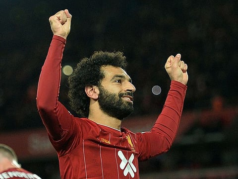 Liverpool's Egyptian midfielder Mohamed Salah celebrates after scoring a penalty.