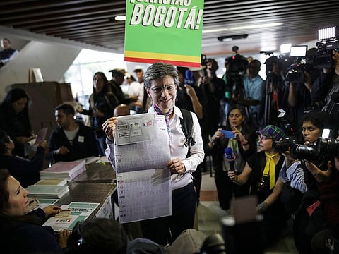 Claudia Lopez, candidate for Mayor of Bogota for the Green Alliance, shows her ballot before voting during local and regional elections in Bogota, Colombia, Sunday, Oct. 27, 2019. Colombians went to the polls Sunday to choose mayors, state governors and local assemblies.