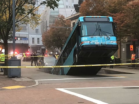 Authorities investigate after a Port Authority bus was caught in a sinkhole in downtown Pittsburgh.