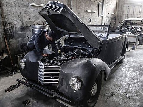 Munir Shindy, a 40-year-old Palestinian who restores old cars as a hobby, works on a 1946 Armstrong Siddeley at his workshop in Gaza City.