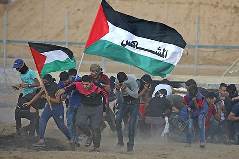 Palestinian demonstrators react during an anti-Israel protest at the Israel-Gaza border fence in the southern Gaza Strip October 25, 2019