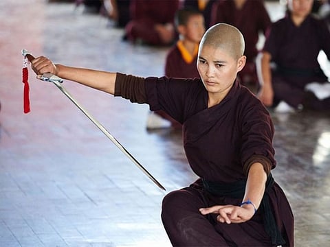A nun trains with a swords.