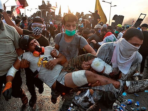 An injured protester is rushed to a hospital during an anti-government protest in Baghdad, Iraq, Tuesday, Oct. 29, 2019.