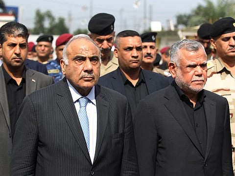 Iraq's Prime Minister Adel Abdel Mahdi (L) and Hadi al-Ameri, leader of the mostly Shiite Hashed al-Shaabi paramilitary units, attend a symbolic funeral ceremony in Baghdad on October 23, 2019 for Major General Ali al-Lami, a commander of the Iraqi Federal Police's Fourth Division, who was killed the previous day in Samarra in the province of Salahuddin, north of the Iraqi capital.