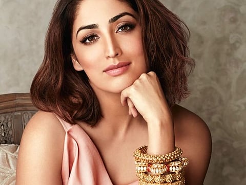 Yami Gautam starts her Monday flaunting a modern yet traditional avatar. The Bollywood beauty posted a picture of her on Instagram where she is seen in a modern peach-coloured dress, which she has teamed up with traditional heavy gold bangles. Yami has chosen to keep her makeup minimal using nude shades of lipstick and eye shadow and she looks stunning.