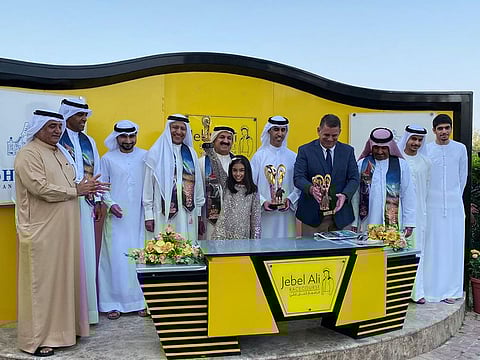 Mirza Al Sayegh and officials during the presentation ceremony of the Shandwell trophy at Jebel Ali Racecourse on Friday. Mystique Moon, trained by Doug Watson, won the feature race.