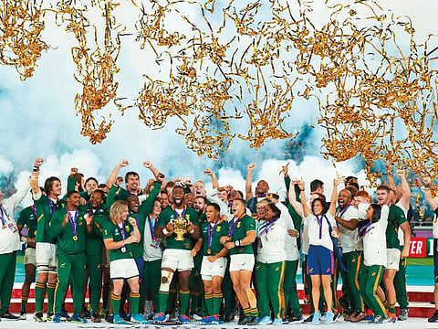 Members of South African rugby team pose with the Webb Ellis Trophy after winning the Rugby World Cup at Yokohama on Saturday.