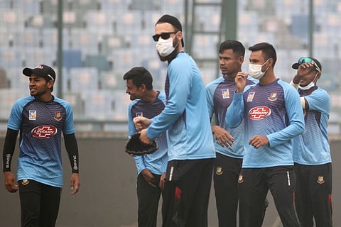 Bangladesh'a cricketers wear musks during a practice session to fight the heavy smog conditions at Arun Jaitley Cricket Stadium in New Delhi on Saturday.
