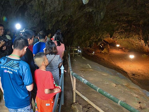 People visit Tham Luang cave in the Mae Sai district of Thailand's northern Chiang Rai province.