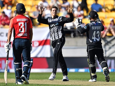 New Zealand's Mitchell Santner (centre) celebrates taking the wicket of England's Chris Jordan during their second Twenty20 match at Westpac Stadium in Wellington today.