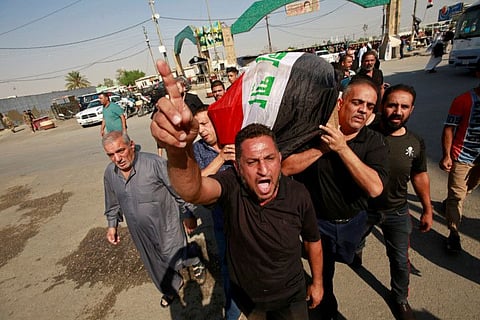 A mourner reacts as others carry the coffin of a demonstrator who was killed at anti-government protests, during a funeral in Najaf, Iraq November 5.