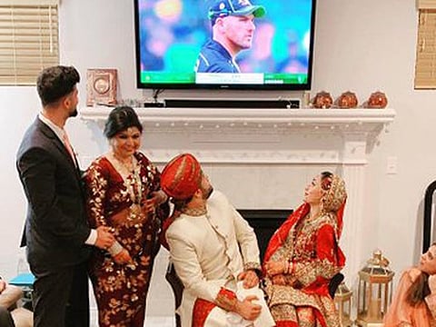 A picture where a newly married Pakistani couple was busy following the second T20I game between Australia and Pakistan on their television set in the US on Tuesday.
