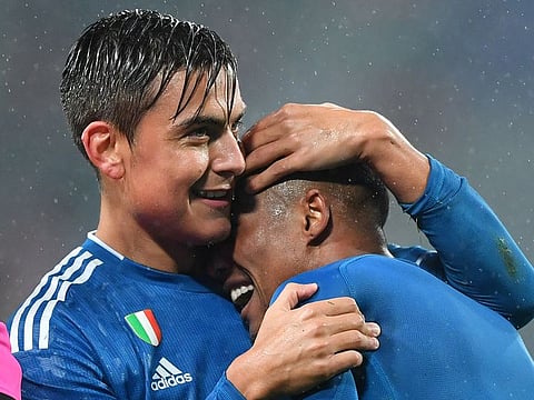 Juventus' Douglas Costa celebrates with Paulo Dybala.