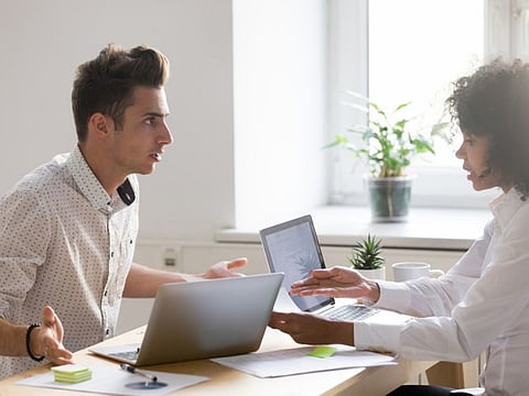 Multiracial colleagues argue about document disagree having conflict at work, diverse coworkers disputing about mistake in paperwork, african businesswoman blaming caucasian partner of bad contract (Multiracial colleagues argue about document disagree