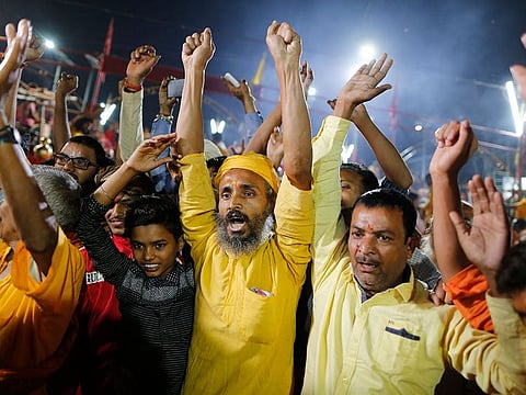 Hindu devotees celebrate the verdict in a decades-old land title dispute between Muslims and Hindus, in Ayodhya, India , Saturday, Nov. 9, 2019.