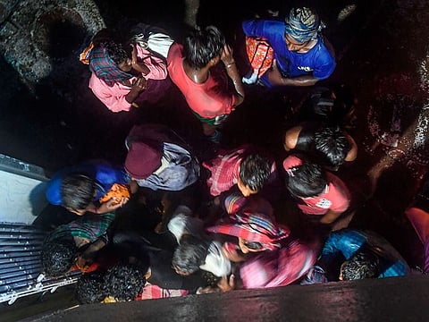 Villagers enter a building to take shelter as Cyclone Bulbul is approaching, in Bakkhali near Namkhana in Indian state of West Bengal on November 9, 2019.