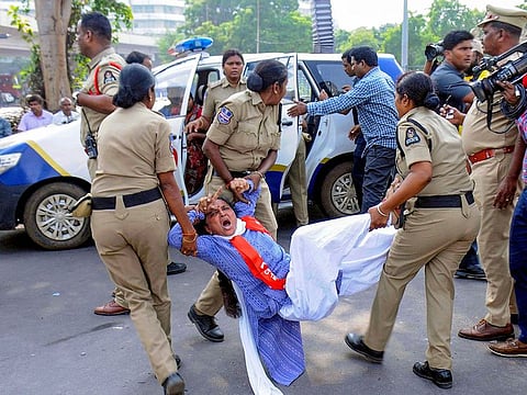 Police personnel detain a protestor during a demonstration, in Hyderabad, Saturday, Nov. 9, 2019