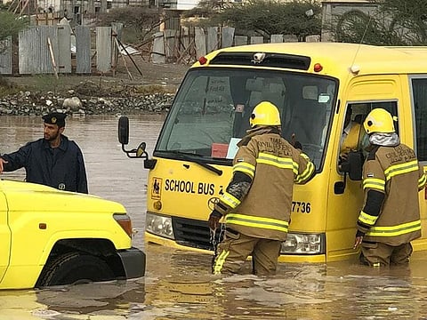 Sharjah Civil Defence helps a school bus stuck in Kalba.