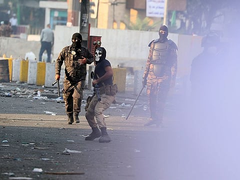 Police use tear gas canisters and sound bombs during ongoing protests in downtown Baghdad, Iraq, Sunday, Nov. 10, 2019.