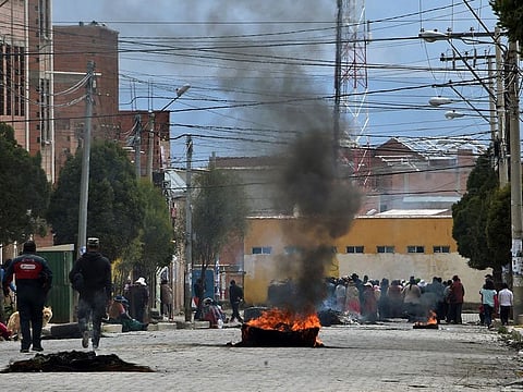 Pro-Evo Morales protesters block a street of El Alto on November 11, 2019, a day after the resignation of the leftist leader as president of Bolivia.